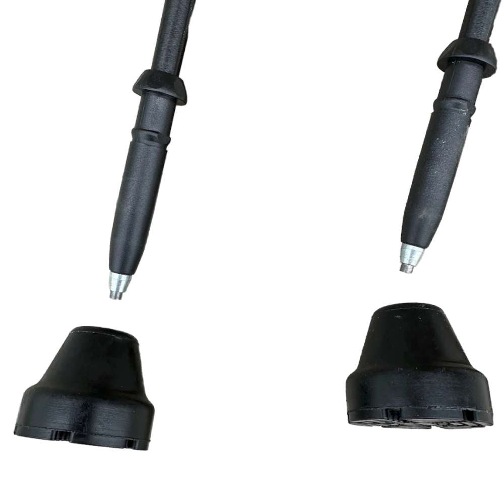 Two black rubber boots with metal tips on a white background