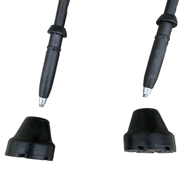 Two black rubber boots with metal tips on a white background