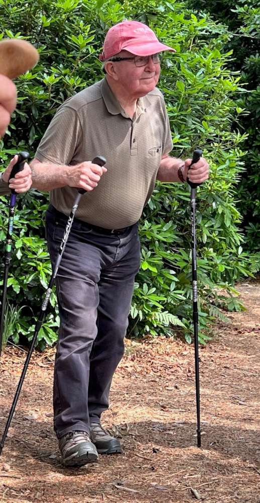 Man holding WALX poles on a trail