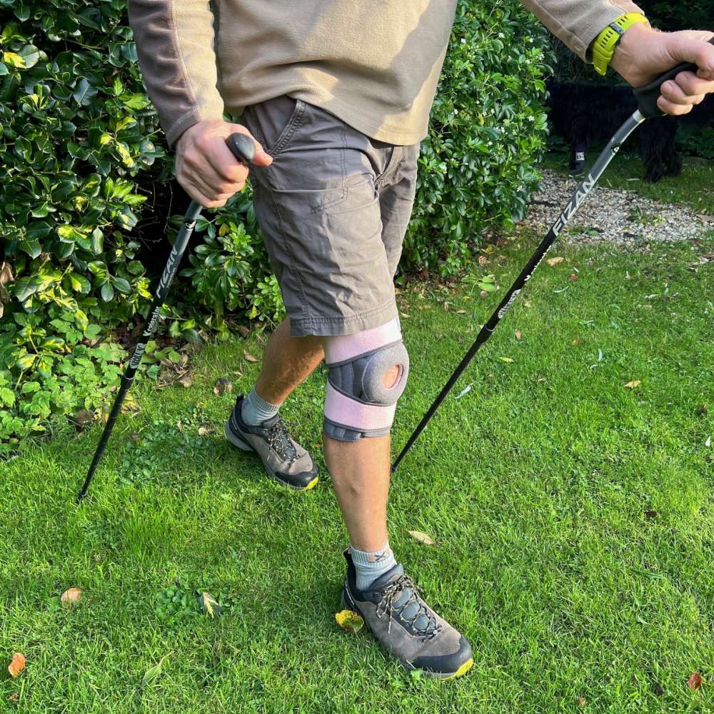 Person using Xcelerator poles on grass with a knee brace